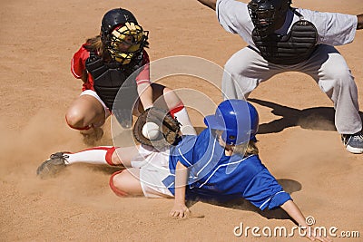 Softball Player Sliding Into Home Plate