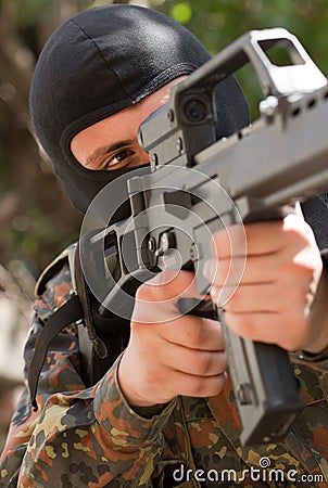 Soldier in black mask with a gun