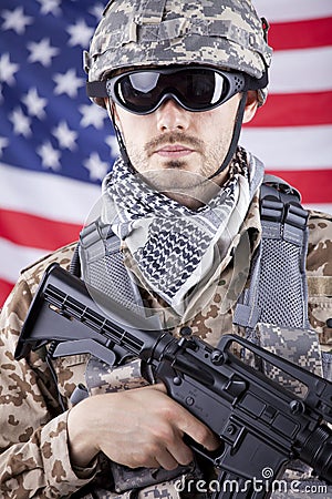 Soldier with gun over american flag