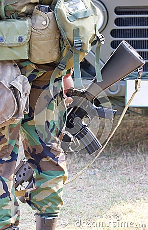 A Soldier Holding A Gun In Hand.