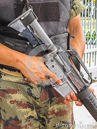 Soldier holding a machine gun.