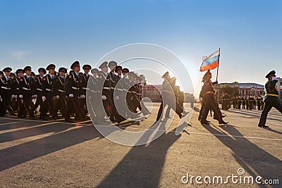 Soldiers with flag marching on parade