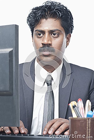 South Indian businessman working on a computer