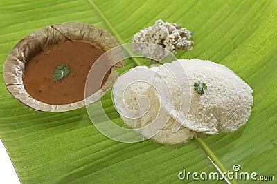 South indian fast food idli with coriander leaf with Sambar and coconut chutney. .