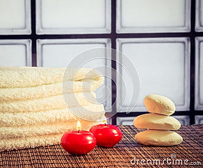 Spa massage border background with towel stacked stone and red candles warm atmosphere