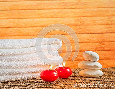 Spa massage border background with towel stacked stone and red candles warm atmosphere