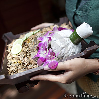 Spa massage setting with thai herbal compress stamps on woman ha