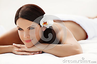 Spa Woman. Beautiful young woman relaxing after massage. Spa sal