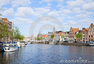 Spaarne river with boats and historical houses in old Haarlem, Holland 