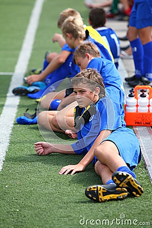 Spare players laying on football field