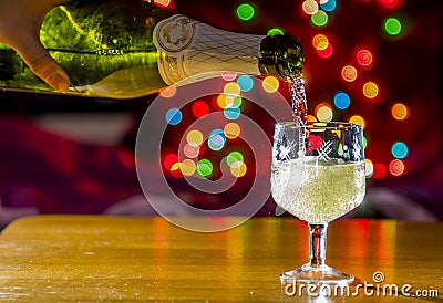 Sparkling wine is poured into the glass