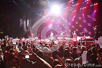 Spectators hold American flags on DAUGHTRY group performs