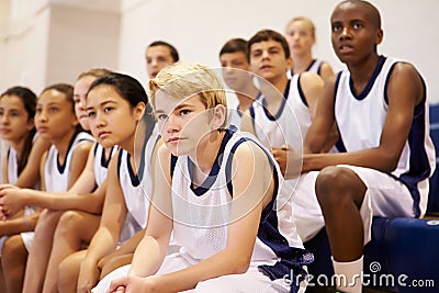 Spectators Watching High School Basketball Team Match