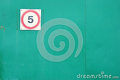 Speed limit to 5 sign on the green gate