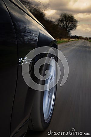Speeding car on country road