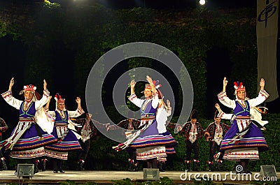 Spinning folk female dancers on stage