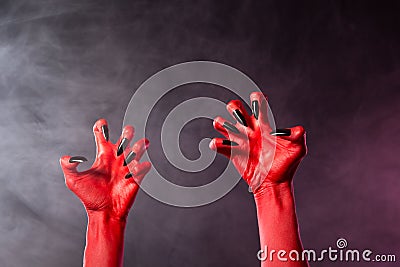 Spooky red devil hands with black glossy nails
