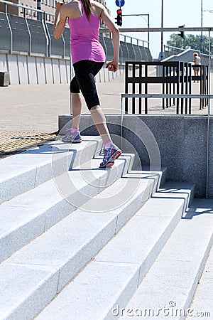 Sport. Attractive girl running on the street