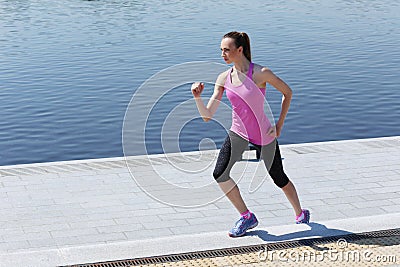 Sport. Attractive girl running on the street