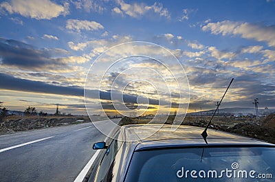Sport car drive road to sunset horizon