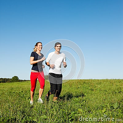 Sport couple jogging outdoors in summer