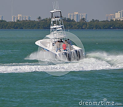 Sport fishing boat powered by four outboard engines taking a high ...