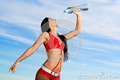 Sport girl in red uniform with a bottle of water