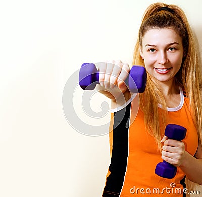 Sportive athletic woman working out with dumbbells