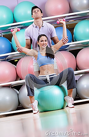 Sportive woman exercises in fitness gym
