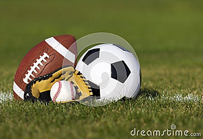 Sports balls on the field with yard line. Soccer ball, American football and Baseball in yellow glove on green grass