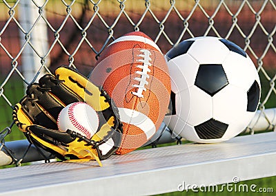 Sports balls. Soccer ball, american football and baseball in glove. Outdoors