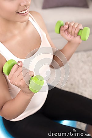 Sports at home. Top view of beautiful young women exercising at home