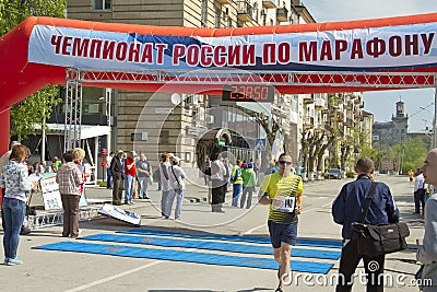 Sportsmen participants of the Volgograd marathon run through the finish line
