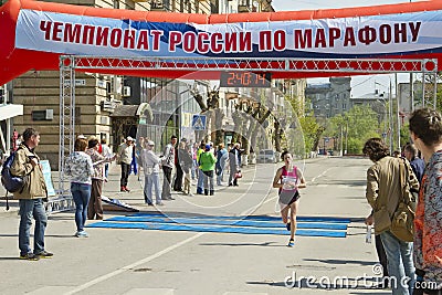 Sportsmen participants of the Volgograd marathon run through the finish line