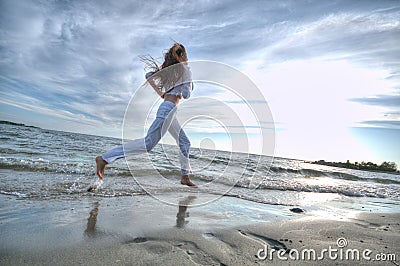 Sporty woman running in sea coast