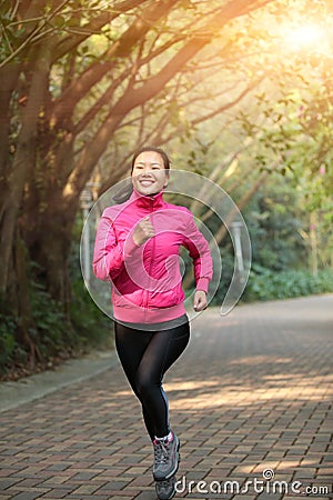 Sporty woman running at trail