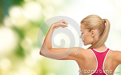 Sporty woman showing her biceps