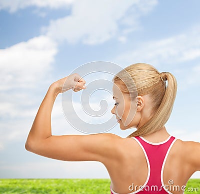 Sporty woman showing her biceps