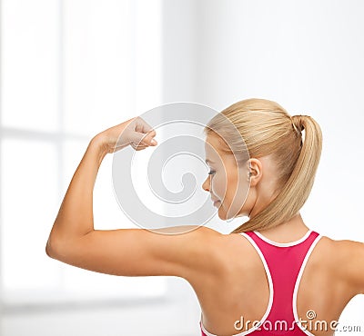 Sporty woman showing her biceps