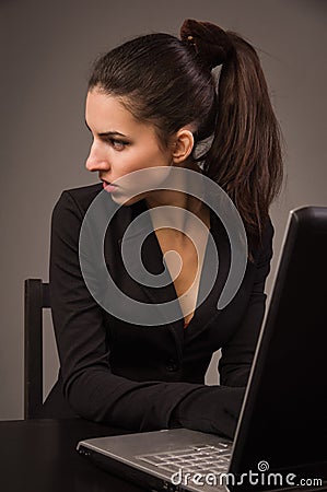 Spy girl in a black with laptop