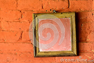 Square mirror on a brick wall