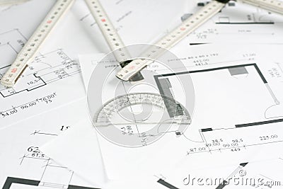 Square set and measurement tool over blueprints