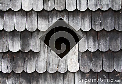 Square window in a wood cabin