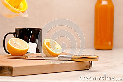 Squeezed lemon poured in a cup of tea