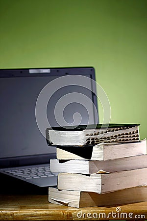 Stack of books and a Computer laptop