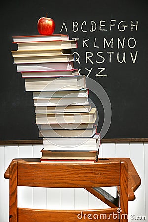 Stack of books on an old school desk