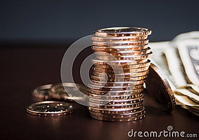 Stack of gold coins with cash