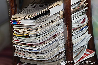 Stack of newspapers and magazines in reading table