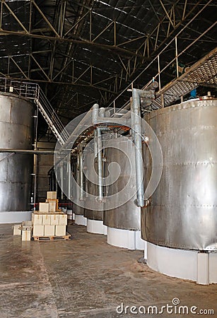 Stainless steel wine vats in a row at a winery