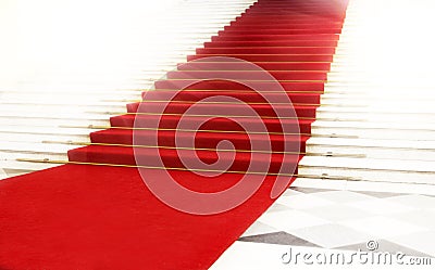 Staircase with red carpet, illuminated by light